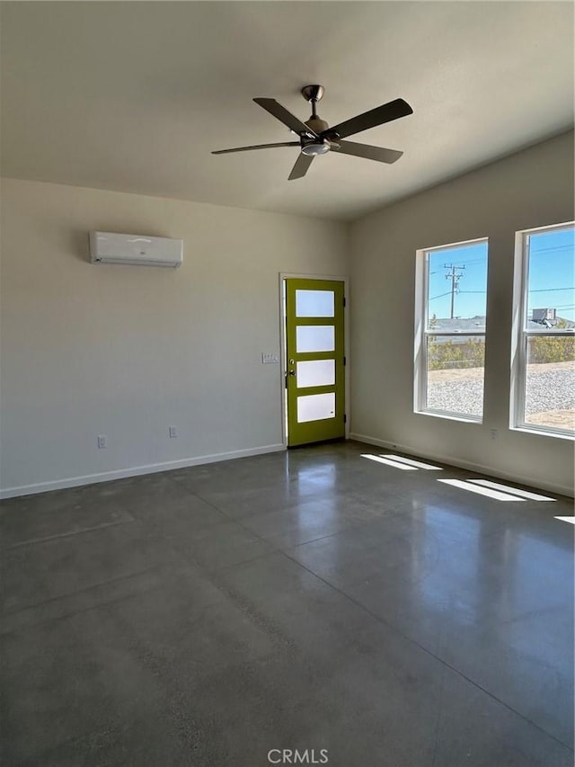 empty room featuring ceiling fan and a wall mounted air conditioner