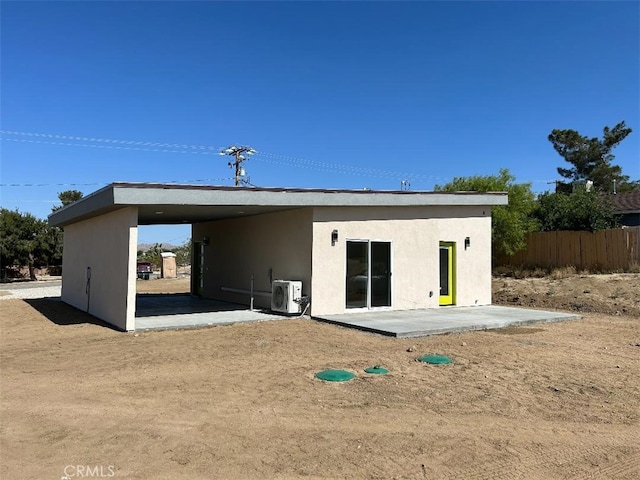 back of property with a patio area and ac unit