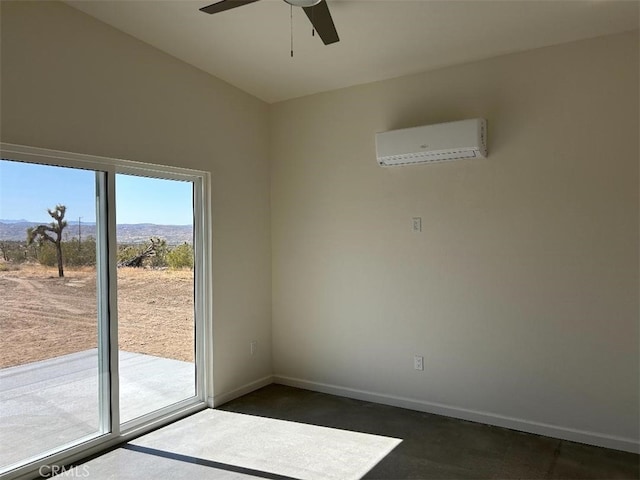 spare room with ceiling fan, a mountain view, and a wall mounted air conditioner