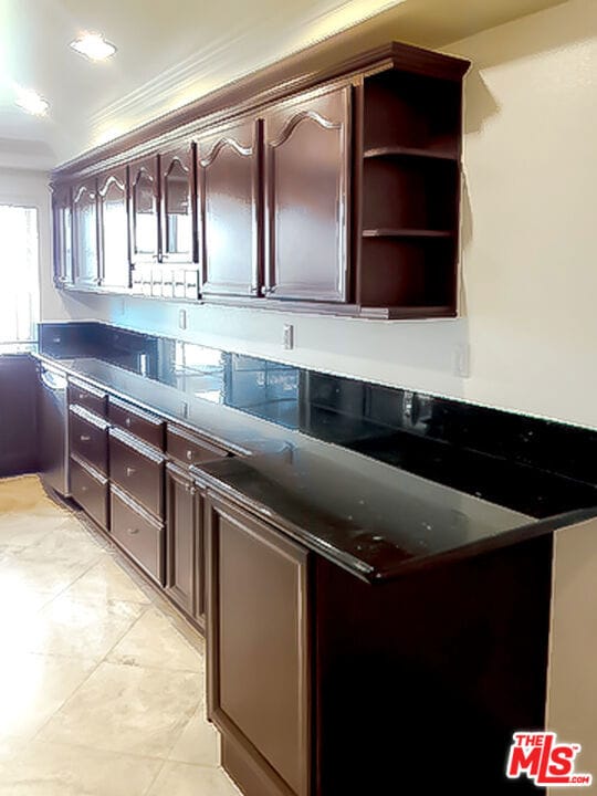 kitchen with dark brown cabinets and ornamental molding