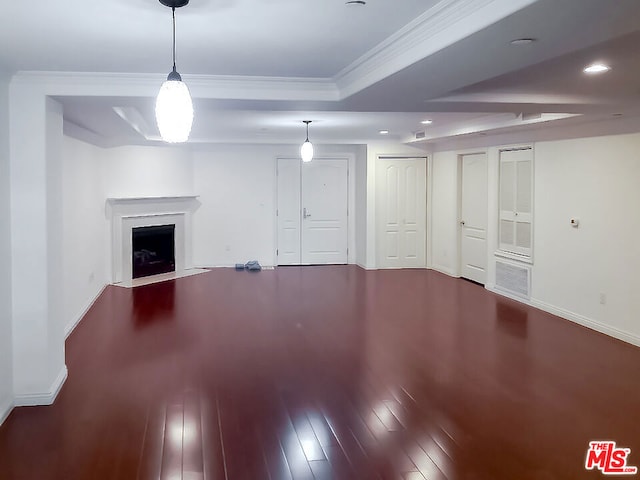 unfurnished living room featuring ornamental molding and hardwood / wood-style flooring