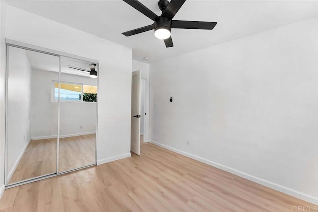 unfurnished bedroom featuring ceiling fan, a closet, and light hardwood / wood-style floors