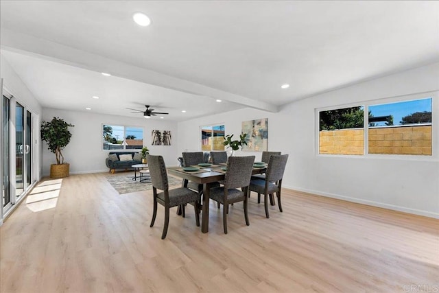 dining area featuring beamed ceiling, ceiling fan, and light wood-type flooring