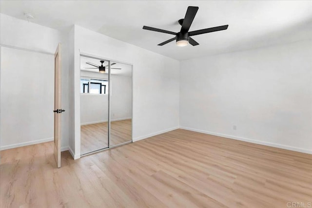 unfurnished bedroom featuring a closet, ceiling fan, and light hardwood / wood-style flooring