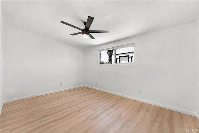 spare room with light wood-type flooring and ceiling fan