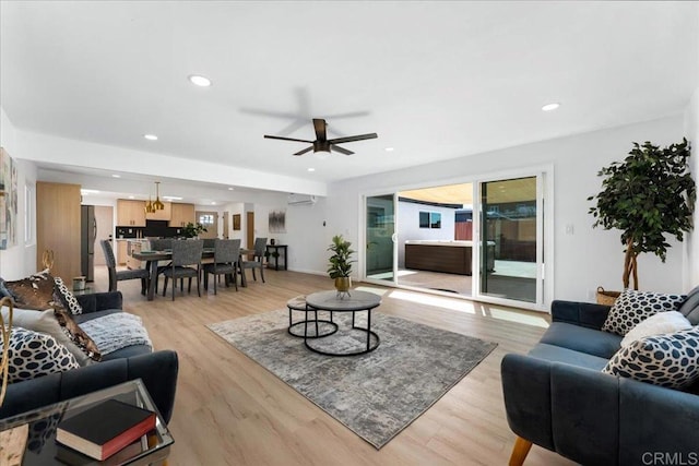 living room featuring ceiling fan and light hardwood / wood-style flooring