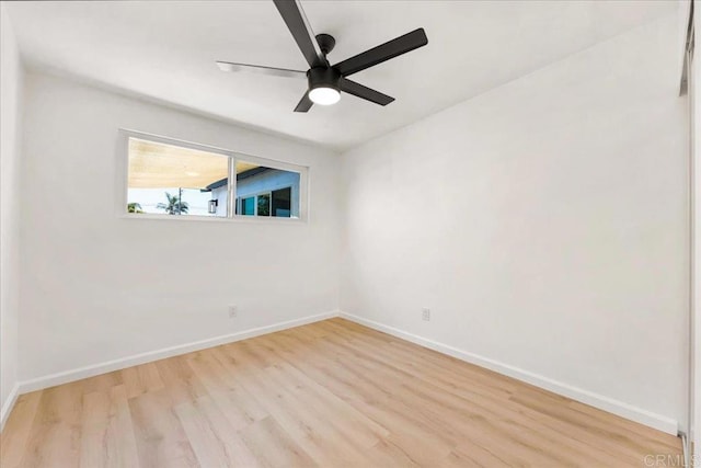 empty room with ceiling fan and light hardwood / wood-style flooring