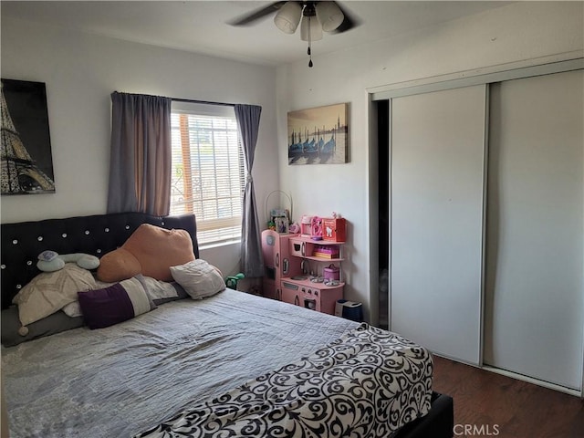 bedroom with ceiling fan, a closet, and hardwood / wood-style floors