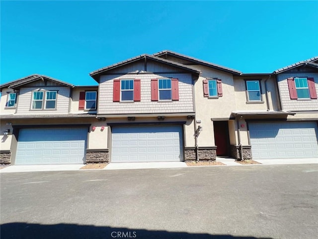 townhome / multi-family property featuring a garage