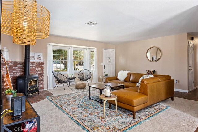 living room with a wood stove and carpet flooring