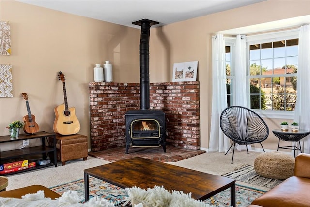 carpeted living room featuring a wood stove