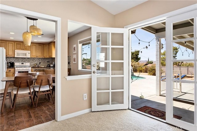 entryway featuring a wealth of natural light and carpet floors