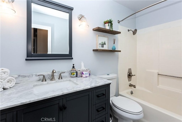 full bathroom featuring toilet, tiled shower / bath, and vanity