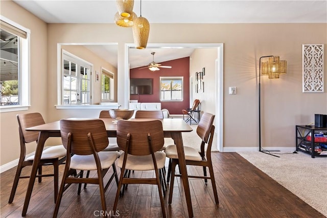 dining area with ceiling fan, dark hardwood / wood-style flooring, and lofted ceiling