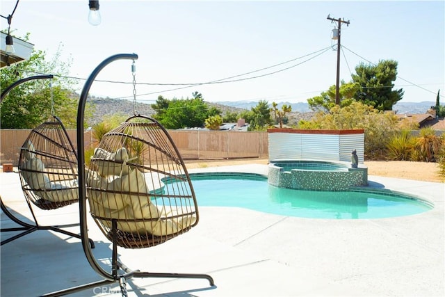 view of pool with an in ground hot tub and a patio