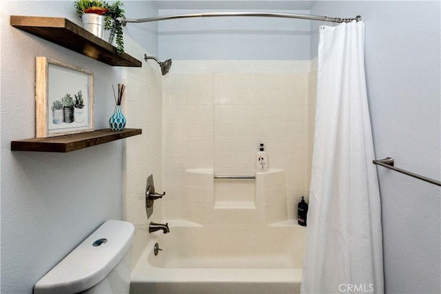 bathroom featuring toilet and shower / bath combination with curtain