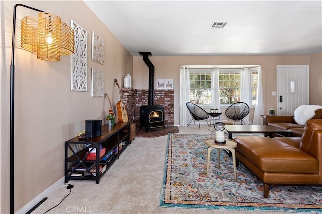 carpeted living room featuring a wood stove