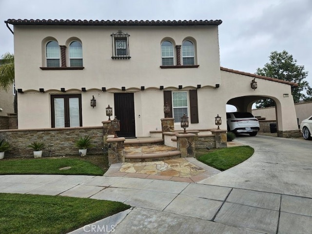 mediterranean / spanish-style home with a carport