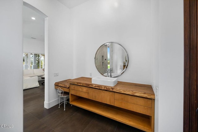 corridor featuring dark hardwood / wood-style flooring and sink