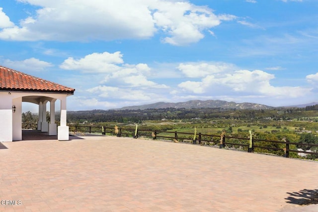 view of patio with a mountain view and a rural view