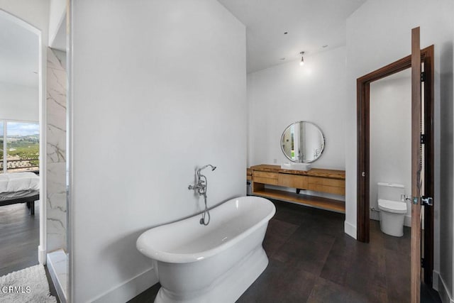 bathroom with hardwood / wood-style flooring, toilet, and a tub