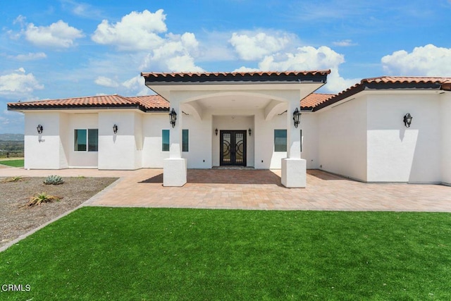 back of house featuring french doors and a yard