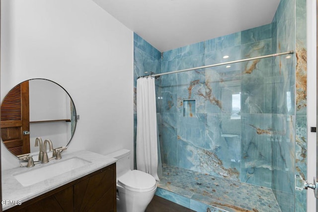 bathroom with toilet, vanity, and a shower with shower curtain