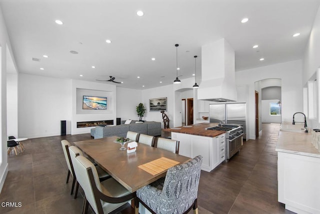 dining room featuring ceiling fan and sink