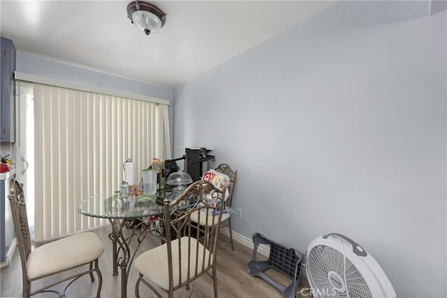 dining room featuring baseboards and light wood-style floors