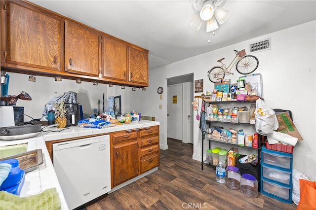 kitchen with tile counters, ceiling fan, dishwasher, and dark hardwood / wood-style floors