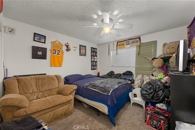 carpeted bedroom featuring ceiling fan and a textured ceiling