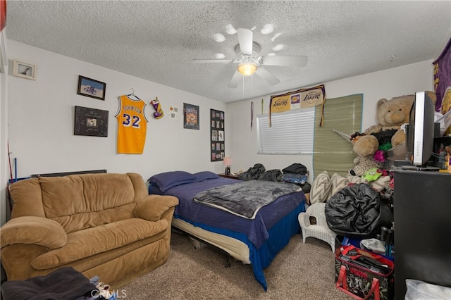 carpeted bedroom featuring ceiling fan and a textured ceiling