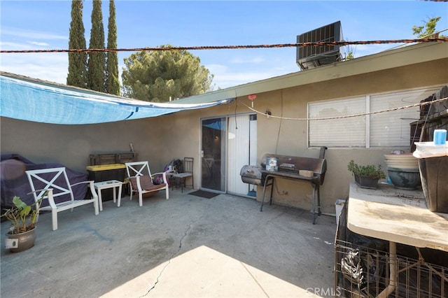 view of patio with central air condition unit and area for grilling