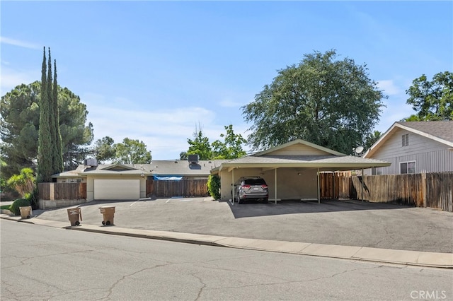 single story home featuring a garage and a carport