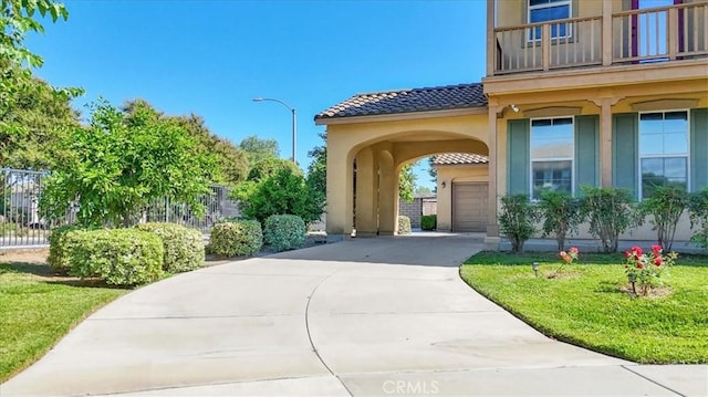 view of exterior entry with a balcony and a garage