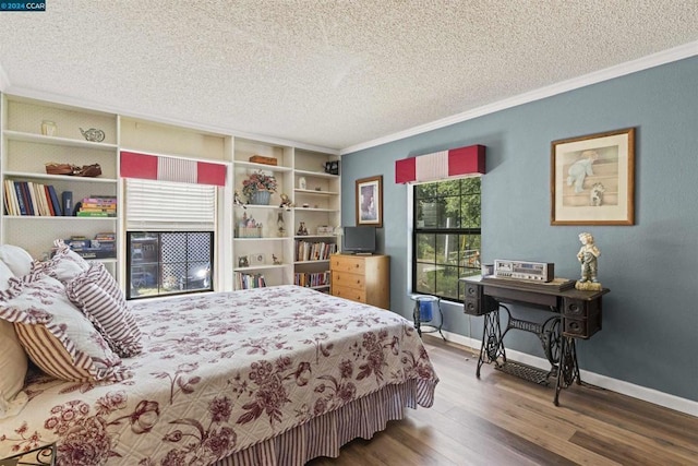 bedroom with crown molding, wood-type flooring, and a textured ceiling