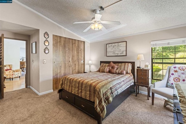 bedroom featuring carpet floors, crown molding, vaulted ceiling, and a textured ceiling