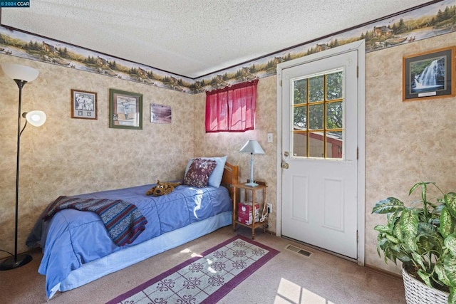 carpeted bedroom featuring a textured ceiling