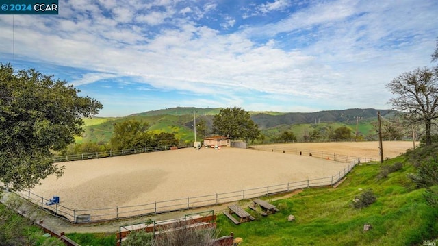 view of home's community with a mountain view and a rural view