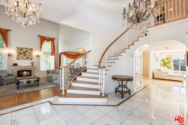 entrance foyer featuring a wealth of natural light, a high ceiling, and tile floors