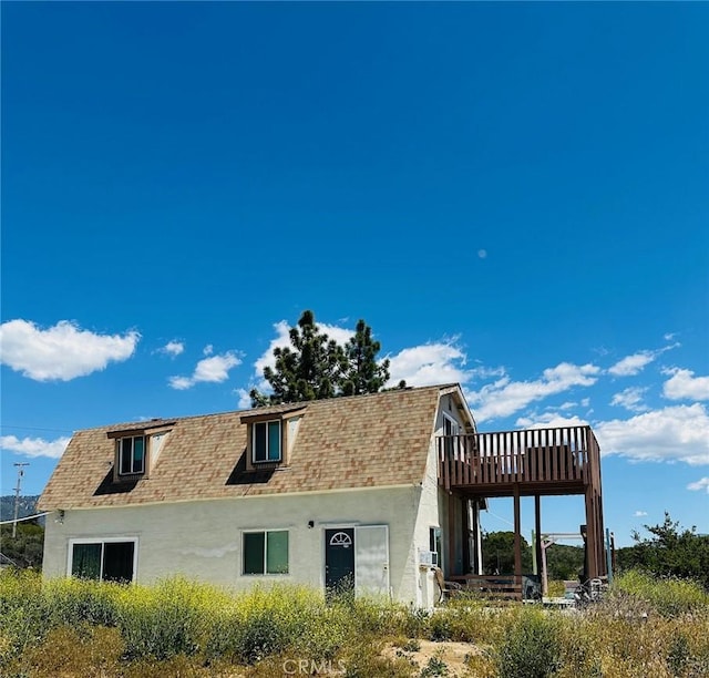 rear view of property with a deck