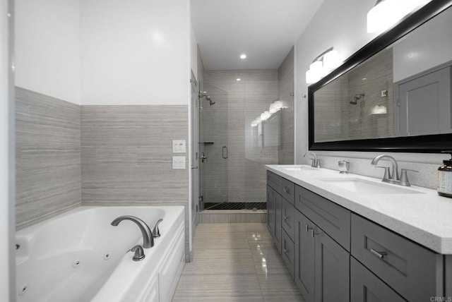 bathroom with tile patterned flooring, vanity, and plus walk in shower