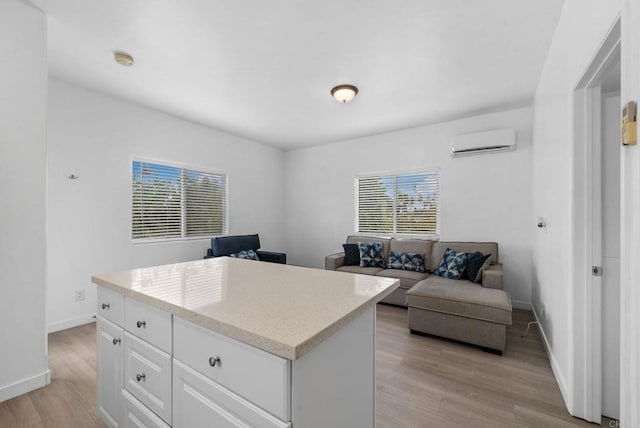 office with light hardwood / wood-style flooring and a wall mounted air conditioner