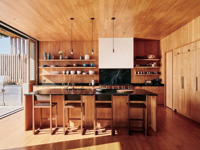 bar featuring dark hardwood / wood-style flooring, wood ceiling, and decorative light fixtures