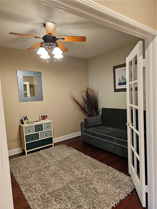 sitting room featuring ceiling fan and dark hardwood / wood-style floors