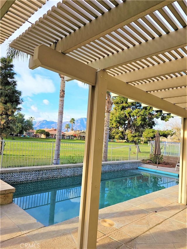 view of pool featuring a lawn, a mountain view, a pergola, and a patio