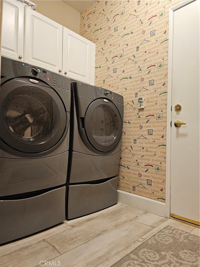 laundry area with cabinets and independent washer and dryer