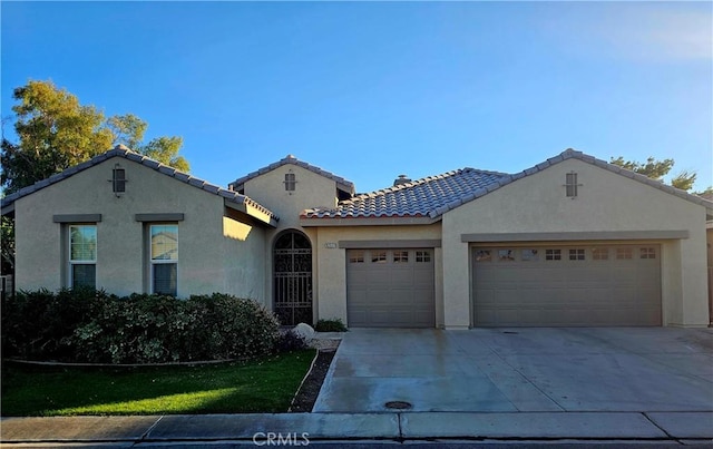 mediterranean / spanish house with a garage