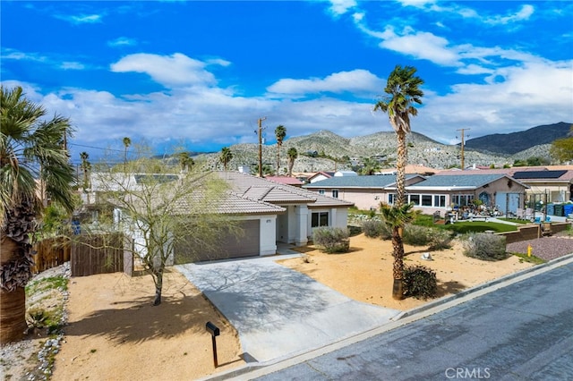 view of front facade with a mountain view and a garage