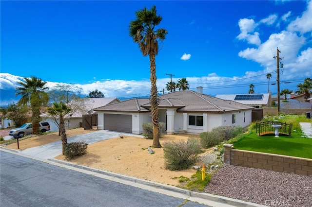 ranch-style home featuring a front lawn and a garage